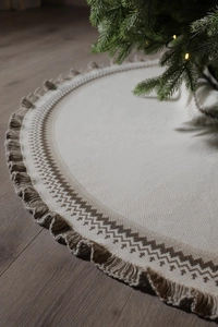 Detail of knitted Christmas tree skirt with Fair Isle patterns and decorative tassels