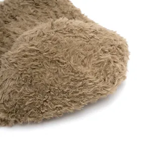 Close-up of brown plush knit hat top with durable stitching and fluffy texture