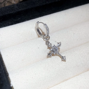 Close-up of S925 silver cross pendant earrings with shimmering cubic zirconia