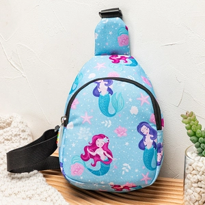 Detail of blue mermaid kids crossbody bag on wooden stand with star and shell patterns