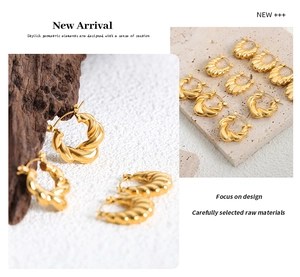 Macro detail of French style gold twisted hoop earrings with textured spiral design