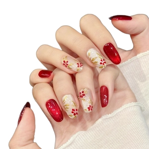 Handmade red cat eye press-on nails with glitter, gold leaf, and floral hand-painted art