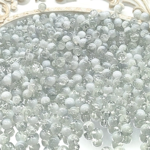 Macro detail of 10mm white cracked glass beads showing icy textures for DIY jewelry