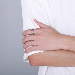 Close-up of a silver twisted irregular ring worn on hand with a modern minimalist style