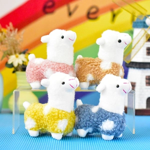 Close-up of colorful plush alpaca doll pendants with curly fleece texture for gifts