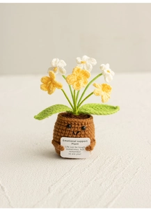 Detail of crochet lily of the valley with emotional support card in brown knit pot