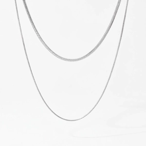 Close-up of minimalist silver double-layer snake chain necklace in polished steel
