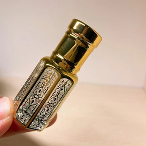 Detail of laser coated octagonal crystal essential oil bottle with silver hollow pattern