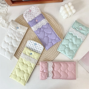 Detailed view of quilted heart fabric pouches with lace trim and heart-shaped buttons