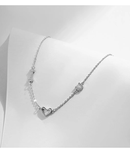 Macro detail of silver S925 heart bracelet with crystal I Love You charms