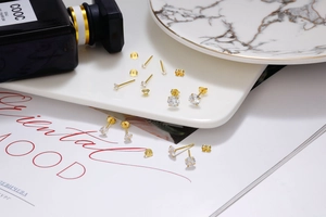 Detailed close-up of S925 sterling silver gold-plated stud earrings with round zircons