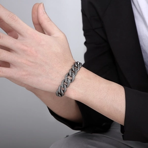 Retro stainless steel Cuban link bracelet featuring textured ring links on male model