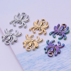 Macro shot of spider pendant accessories in polished silver, gold, and rainbow finish