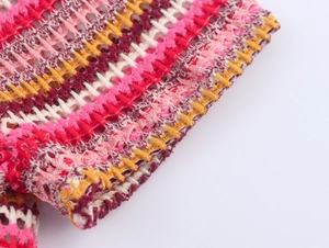 Close-up of colorful striped crochet knit fabric showing detailed hollow out texture
