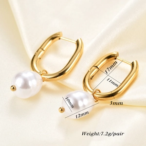 Detailed view of U-shaped gold earrings with faux pearl drops and size measurements
