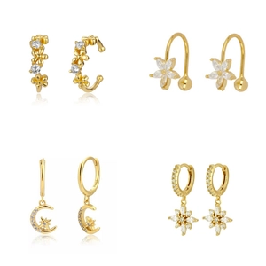 Luxurious gold earrings set with cubic zirconia featuring flower and star patterns