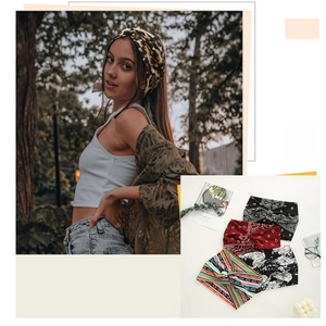 Detailed view of four elastic wide headbands with floral, leopard and paisley prints