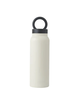 Close-up of cream insulated water bottle with black magnetic ring handle lid