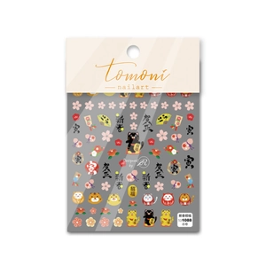 Detailed macro view of 5D embossed Japanese nail art stickers with Daruma and lucky cat icons