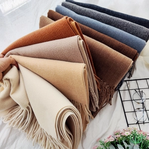 Double-sided cashmere-like scarves in earthy tones with fringes and soft texture