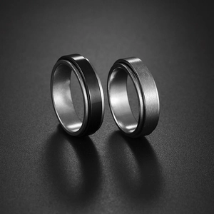 Minimalist 6mm stainless steel spinner rings in black and silver brushed metal finish