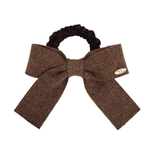Brown knitted bow hair tie with metal Love Is Forever tag on a white background
