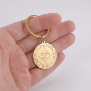 Golden stainless steel keychain with intricately engraved Celtic knot and witch knot pendant