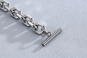 Macro detail of silver stainless steel O-chain bracelet with OT toggle clasp closure