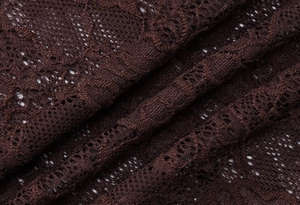 Detailed close-up of dark burgundy lace fabric with intricate floral mesh patterns