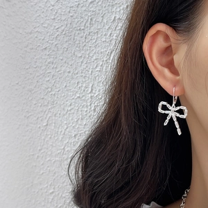 Elegant S925 silver bow earrings with baguette-cut zircon crystals on female model