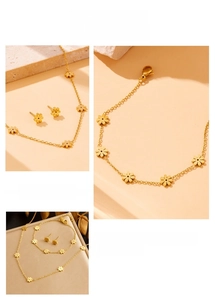 Detail view of gold-plated stainless steel daisy flower necklace and bracelet jewelry set