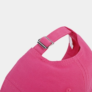 Close-up of pink baseball cap featuring adjustable silver metal buckle and neat stitching