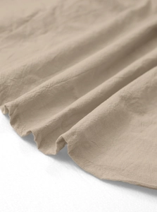Macro shot of the khaki linen cotton fabric texture and stitching details of the shirt set