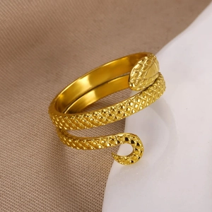 Macro shot of gold snake ring featuring detailed diamond-shaped scale textures on metal