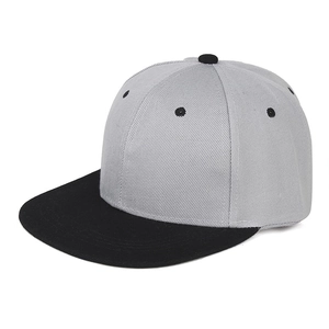 Detail of snapback hat with gray twill crown, black flat brim and embroidered eyelets