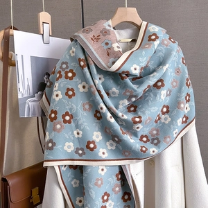 Detail showing vintage blue and brown floral print scarf draped over white coat