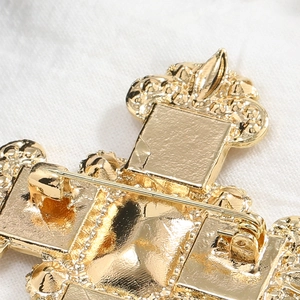 Detailed back view of vintage gold cross brooch with secure pin buckle and relief texture