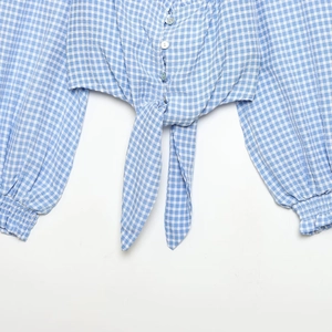 Blue and white plaid blouse for women featuring front tie knot and elastic cuffs