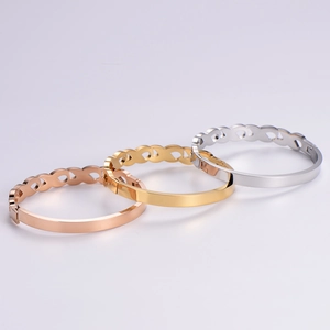 Polished titanium steel bangles in gold, silver, and rose gold with infinity loop design