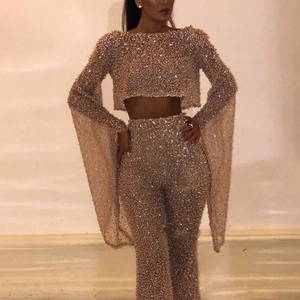 Detail of rose gold sequined two-piece set with long sleeve crop top and high waist pants