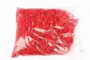 Macro detail of red chili pepper plastic charms for DIY crafts and Lunar New Year decor