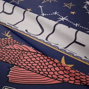 Macro shot of navy tapestry fabric with gold stars and koi scale pattern detail