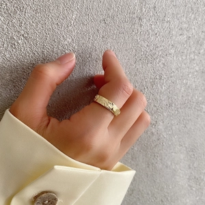 Detailed close-up showing the irregular hammered texture of the wide gold plated ring