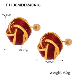 Detail view of dark red enamel knot earrings with gold metal base and size dimensions