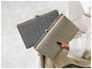 Close-up of black and gold woven evening clutch bags with luxury jewel clasps