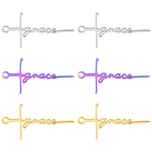 Detailed view of 304 stainless steel cross pendants with grace text in gold and silver