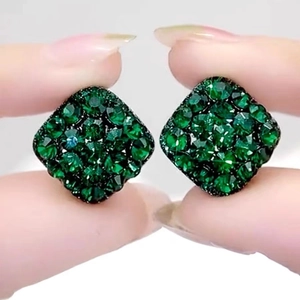 Green crystal square stud earrings with micro-paved rhinestones held by a hand
