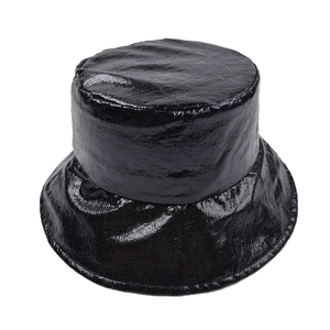 Detailed close-up of glossy black reflective fabric texture on a flat top bucket hat