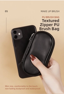 Compact black PU makeup brush bag shown next to a smartphone for size comparison