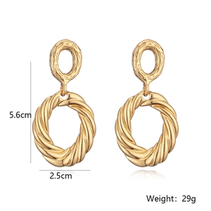 Detail view of gold drop earrings showing 5.6cm height and 2.5cm width dimensions